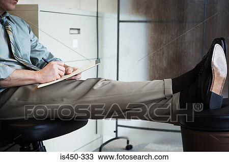 Stock Image - Office worker writing notes. Fotosearch