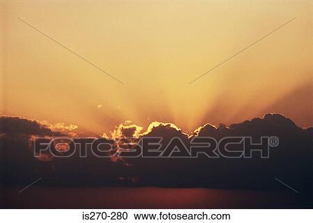 Stock Image - Sun through clouds. Fotosearch