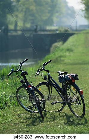 Stock Image - Two bicycles by the river. Fotosearch