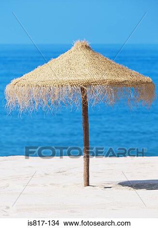 Picture - Straw parasol on beach. Fotosearch