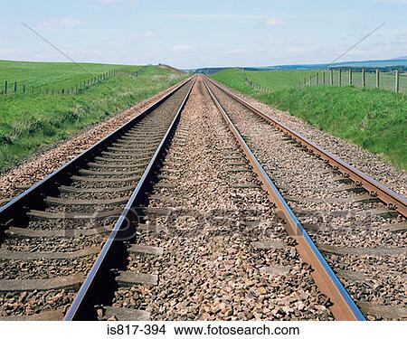 Railway track through countryside View Large Photo Image Picture - Railway track through countryside. Fotosearch