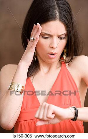 Woman looking at her watch View Large Photo Image Stock Photography - Woman looking at her watch. Fotosearch
