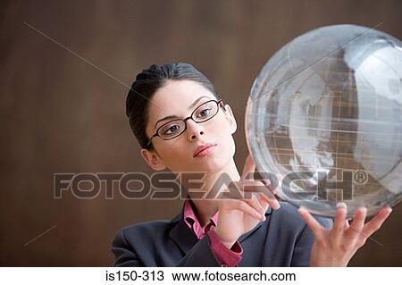 Woman looking at inflatable globe View Large Photo Image Stock Image - Woman looking at inflatable globe. Fotosearch