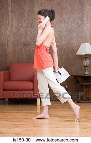 Young woman on cellphone View Large Photo Image Stock Image - Young woman on cellphone. Fotosearch
