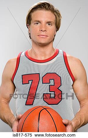 Stock Photography - Basketball player holding basketball. Fotosearch
