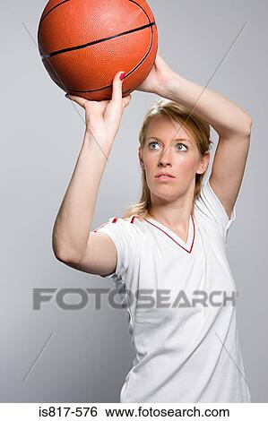 Stock Photograph - Basketball player throwing basketball. Fotosearch