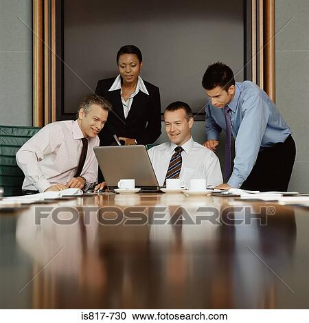 Businesspeople using a laptop computer View Large Photo Image Stock Image - Businesspeople using a laptop computer. Fotosearch