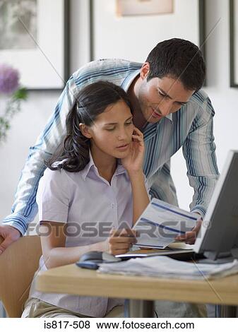 Couple holding bill View Large Photo Image Stock Photo - Couple holding bill. Fotosearch