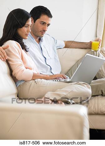 Couple using laptop View Large Photo Image Stock Photograph - Couple using laptop. Fotosearch