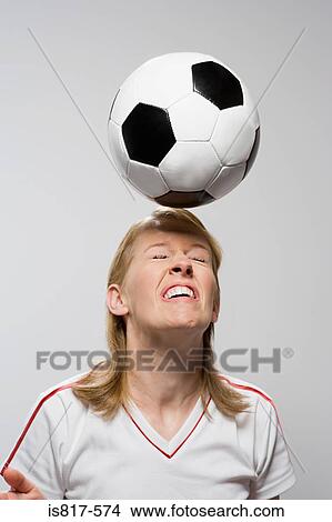 Picture - Footballer heading football. Fotosearch