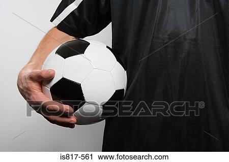 Footballer holding football View Large Photo Image Stock Image - Footballer holding football. Fotosearch