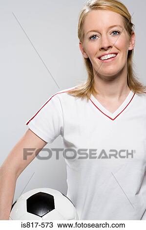 Stock Image - Footballer holding football. Fotosearch