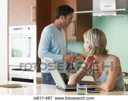 Man and woman in kitchen View Large Photo Image Stock Photo - Man and woman in kitchen. Fotosearch