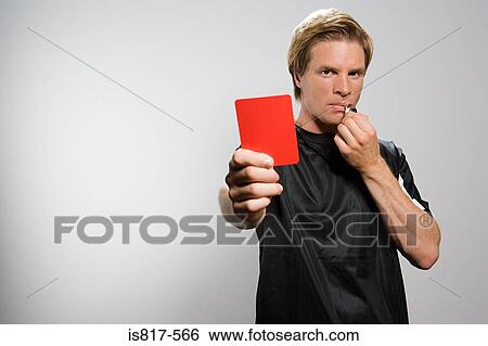 Stock Photograph - Referee holding red card and blowing whistle. Fotosearch
