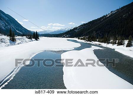 Snow on a lake in mountain valley View Large Photo Image Stock Photo - Snow on a lake in mountain valley. Fotosearch