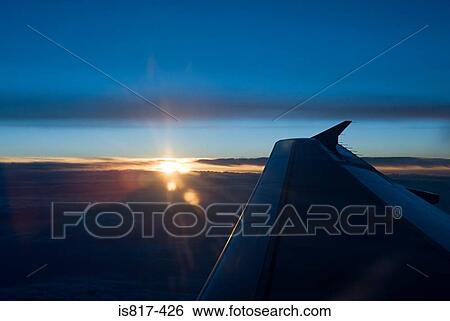 Stock Photograph - Sunset and aeroplane wing. Fotosearch
