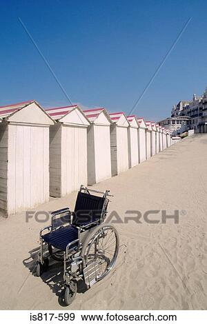 Wheelchair by row of beach huts View Large Photo Image Stock Photo - Wheelchair by row of beach huts. Fotosearch