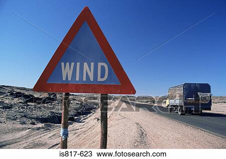 Stock Image - Wind sign and truck on road. Fotosearch