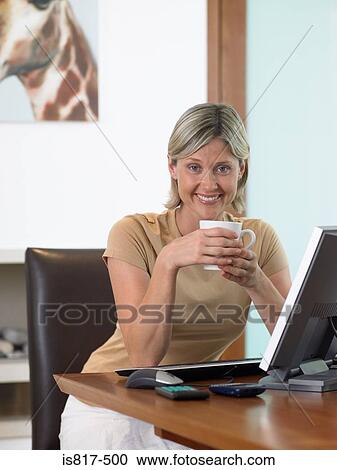 Woman having coffee at computer View Large Photo Image Stock Image - Woman having coffee at computer. Fotosearch