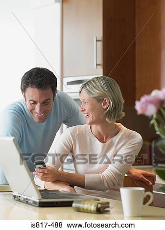 Woman showing cellphone to husband View Large Photo Image Stock Photo - Woman showing cellphone to husband. Fotosearch