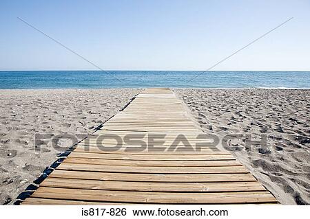 Stock Photograph - Path on an empty beach. Fotosearch