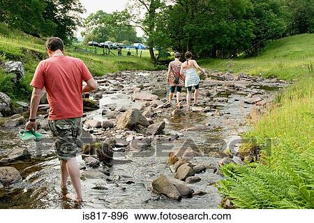 People walking in stream View Large Photo Image Stock Photograph - People walking in stream. Fotosearch