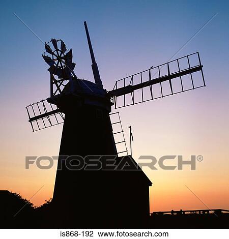 Stock Image - Silhouette of a windmill at sunset. Fotosearch