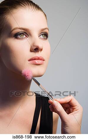 Stock Photo - Woman having make up applied. Fotosearch