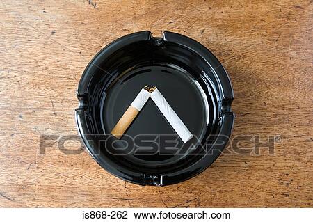 Stock Image - Broken cigarette in an ashtray. Fotosearch