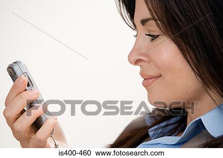 Stock Image - Businesswoman using cell phone. Fotosearch