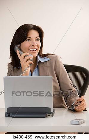 Businesswoman using phone View Large Photo Image Stock Photo - Businesswoman using phone. Fotosearch