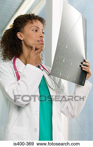 Doctor looking at mri scan View Large Photo Image Stock Photo - Doctor looking at mri scan. Fotosearch