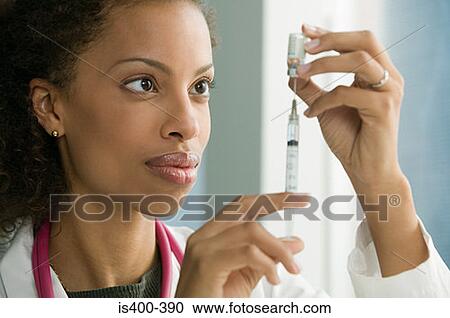 Doctor preparing syringe View Large Photo Image Stock Image - Doctor preparing syringe. Fotosearch