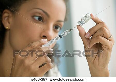 Doctor preparing syringe View Large Photo Image Stock Photo - Doctor preparing syringe. Fotosearch