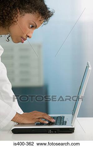 Doctor using laptop View Large Photo Image Stock Image - Doctor using laptop. Fotosearch