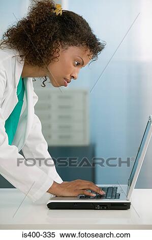 Doctor using laptop View Large Photo Image Stock Photography - Doctor using laptop. Fotosearch