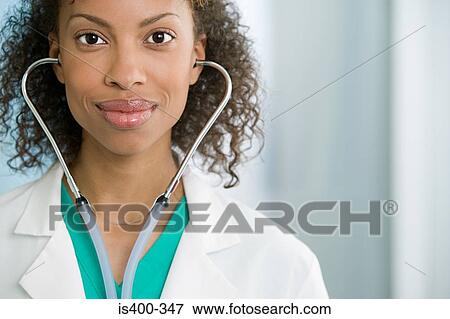 Doctor wearing stethoscope View Large Photo Image Stock Photo - Doctor wearing stethoscope. Fotosearch