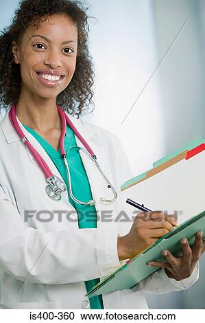 Doctor writing in file View Large Photo Image Stock Image - Doctor writing in file. Fotosearch