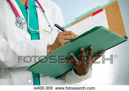 Doctor writing in file View Large Photo Image Stock Photo - Doctor writing in file. Fotosearch