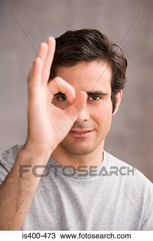 Stock Image - Man doing OK sign. Fotosearch