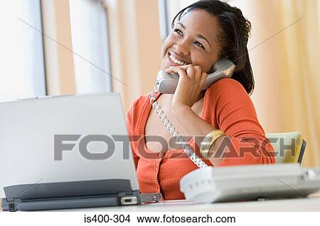 Smiling woman at her desk View Large Photo Image Picture - Smiling woman at her desk. Fotosearch