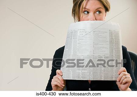 Woman hiding behind newspaper View Large Photo Image Stock Image - Woman hiding behind newspaper. Fotosearch