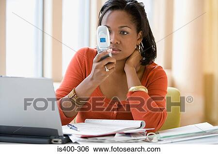 Woman looking at cellphone View Large Photo Image Stock Photograph - Woman looking at cellphone. Fotosearch