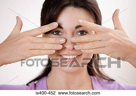 Woman peeking through fingers View Large Photo Image Stock Image - Woman peeking through fingers. Fotosearch