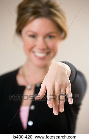 Stock Image - Woman showing engagement ring. Fotosearch