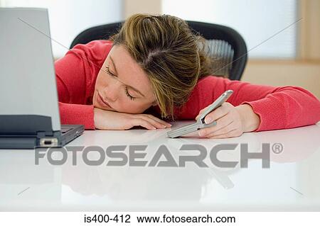Woman sleeping at desk View Large Photo Image Stock Image - Woman sleeping at desk. Fotosearch