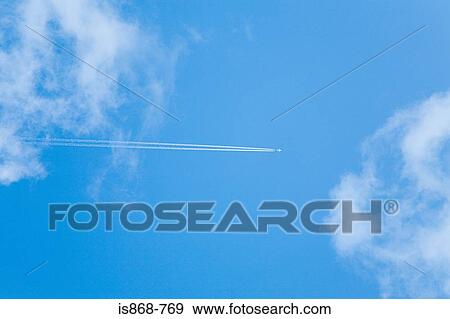 Aeroplane and vapour trail in sky View Large Photo Image Stock Photo - Aeroplane and vapour trail in sky. Fotosearch