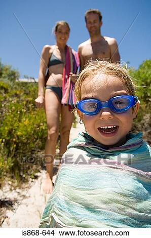 Picture - Boy and parents at the beach. Fotosearch