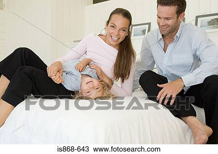 Family on bed View Large Photo Image Stock Image - Family on bed. Fotosearch