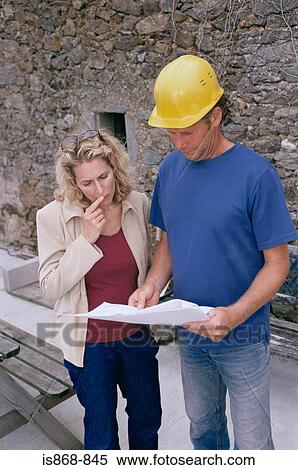 Man and woman looking at plans View Large Photo Image Stock Photography - Man and woman looking at plans. Fotosearch